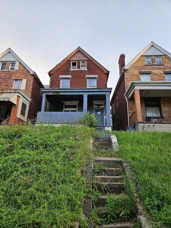 324 Moore Ave, Knoxville, PA 15210 - view of front of home with a porch and brick siding