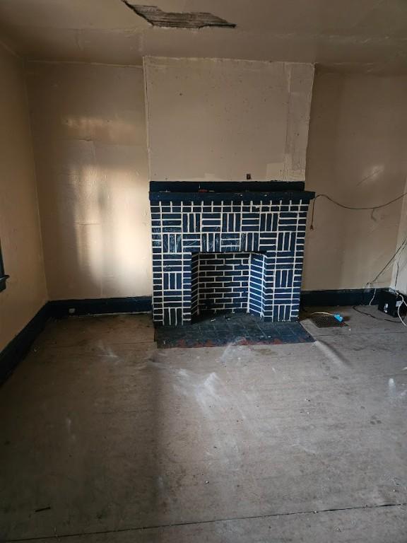324 Moore Ave, Knoxville, PA 15210 - unfurnished living room featuring baseboards and a fireplace
