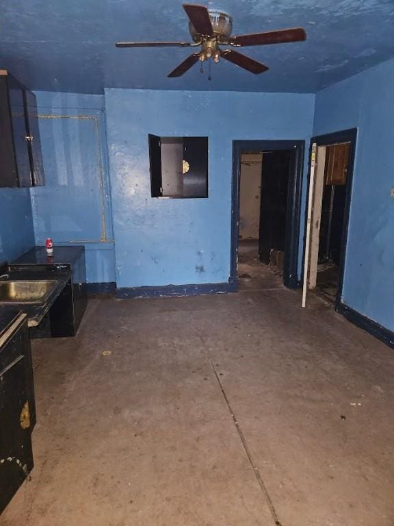324 Moore Ave, Knoxville, PA 15210 - unfurnished living room with ceiling fan and concrete floors