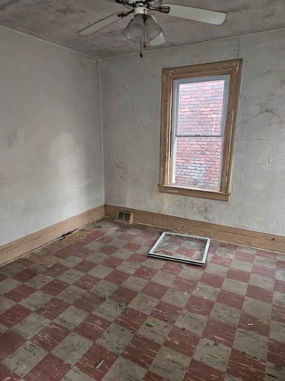 324 Moore Ave, Knoxville, PA 15210 - spare room featuring ceiling fan and tile patterned floors