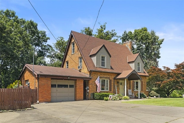 1045 Beverly Ave, Ambridge, PA 15003 - view of front of property featuring an attached garage, brick siding, concrete driveway, and a chimney