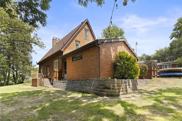 1045 Beverly Ave, Ambridge, PA 15003 - view of side of home with brick siding, a yard, and a chimney