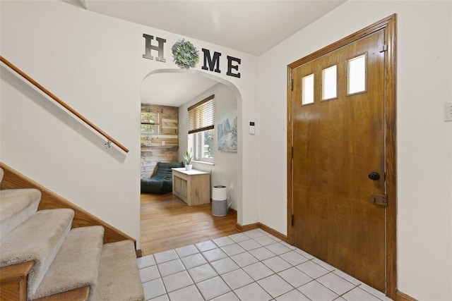1045 Beverly Ave, Ambridge, PA 15003 - entryway with arched walkways, stairs, and light tile patterned floors