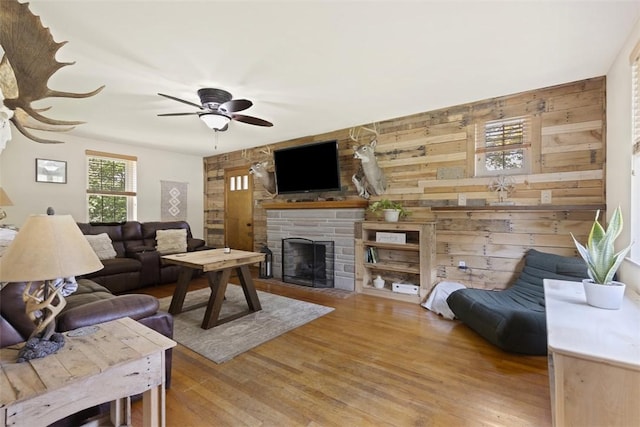 1045 Beverly Ave, Ambridge, PA 15003 - living area featuring ceiling fan, wood finished floors, a fireplace, and wooden walls