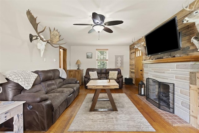 1045 Beverly Ave, Ambridge, PA 15003 - living room with wood finished floors, a ceiling fan, and a stone fireplace