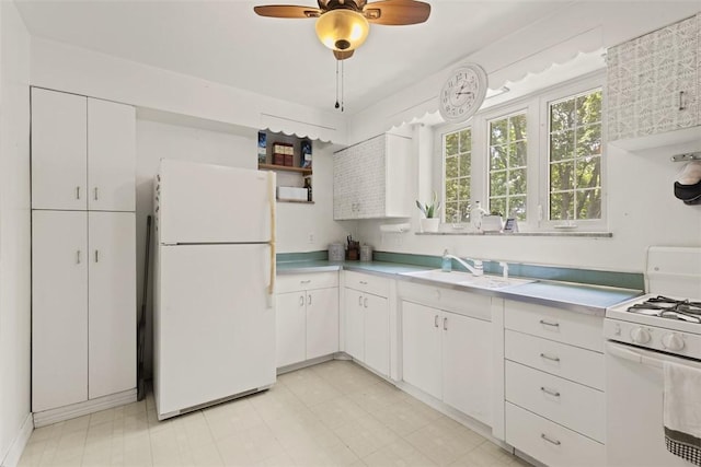 1045 Beverly Ave, Ambridge, PA 15003 - kitchen featuring white appliances, white cabinets, light countertops, and a ceiling fan