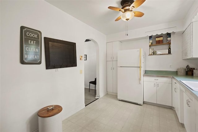 1045 Beverly Ave, Ambridge, PA 15003 - kitchen featuring freestanding refrigerator, ceiling fan, and white cabinets