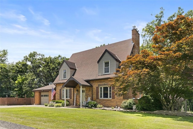 1045 Beverly Ave, Ambridge, PA 15003 - new england style home with a garage, brick siding, driveway, and a chimney