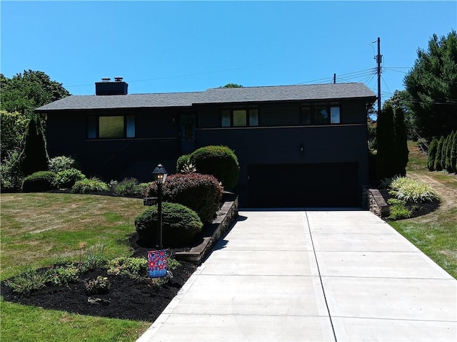 4977 Meadow Park Dr, Whitehall, PA 15236 - view of front of house featuring a garage, concrete driveway, and a chimney