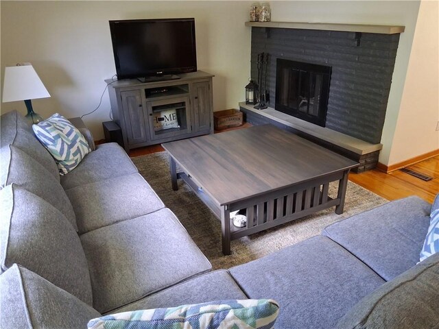 4977 Meadow Park Dr, Whitehall, PA 15236 - living room featuring wood finished floors and a brick fireplace