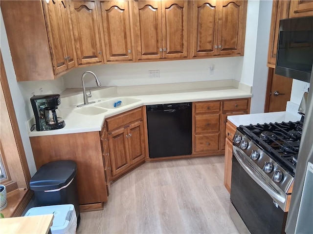 4977 Meadow Park Dr, Whitehall, PA 15236 - kitchen featuring black dishwasher, stainless steel range with gas cooktop, and brown cabinetry
