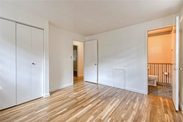 511 New Haven Dr, Hempfield Twp, PA 15601 - unfurnished bedroom with light wood-style floors, ensuite bathroom, and a closet