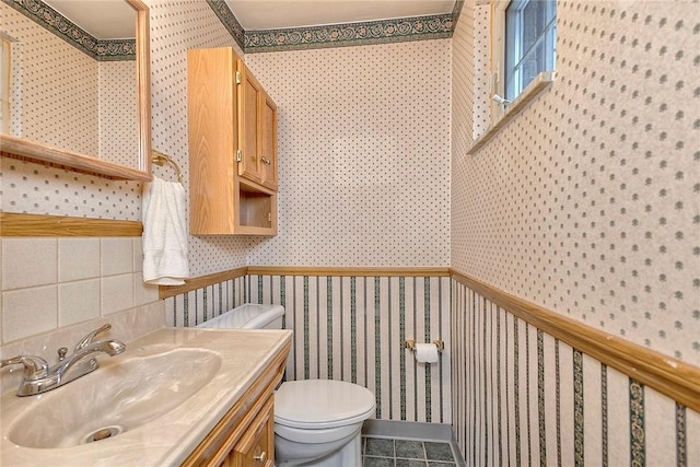 511 New Haven Dr, Hempfield Twp, PA 15601 - half bathroom with wallpapered walls, vanity, and tile patterned flooring