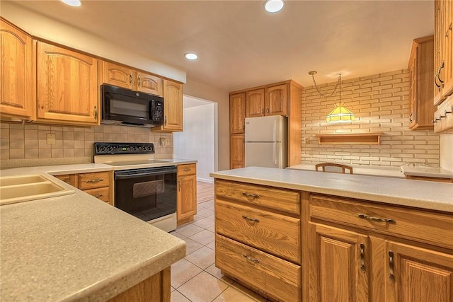 511 New Haven Dr, Hempfield Twp, PA 15601 - kitchen featuring black microwave, range with electric stovetop, freestanding refrigerator, light tile patterned flooring, and decorative backsplash
