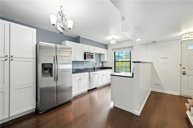 1152 Pennsbury Blvd, Pennsbury, PA 15205 - kitchen featuring stainless steel appliances, dark countertops, dark wood-style floors, and white cabinetry