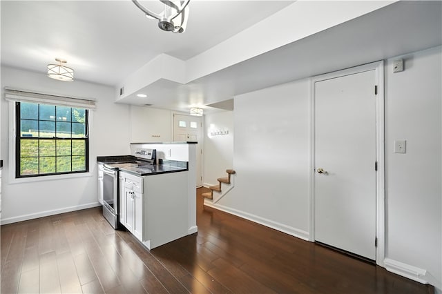 1152 Pennsbury Blvd, Pennsbury, PA 15205 - kitchen with stainless steel range with electric cooktop, dark countertops, white cabinets, and dark wood-style flooring