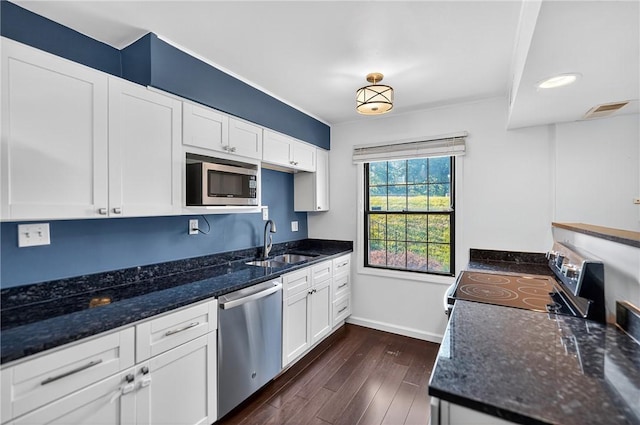 1152 Pennsbury Blvd, Pennsbury, PA 15205 - kitchen featuring stainless steel appliances, dark wood-style floors, white cabinetry, and dark stone counters