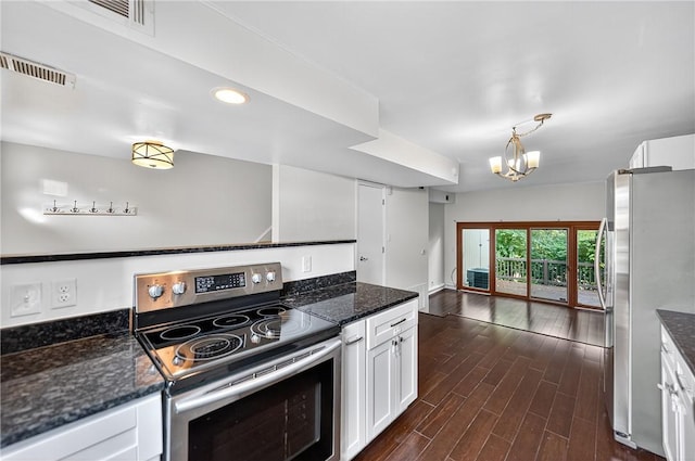 1152 Pennsbury Blvd, Pennsbury, PA 15205 - kitchen featuring appliances with stainless steel finishes, white cabinetry, dark wood-style floors, dark stone countertops, and a chandelier