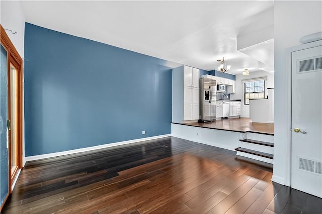 1152 Pennsbury Blvd, Pennsbury, PA 15205 - unfurnished living room with dark wood-type flooring and a chandelier