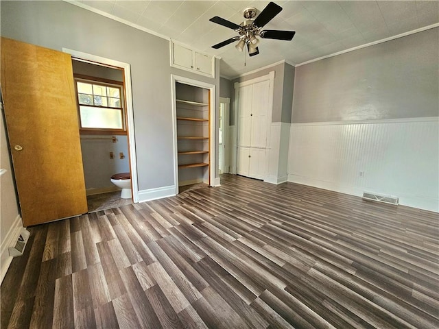 1908 6th Ave, Beaver Falls, PA 15010 - unfurnished bedroom featuring wood finished floors, crown molding, ensuite bathroom, ceiling fan, and a wainscoted wall
