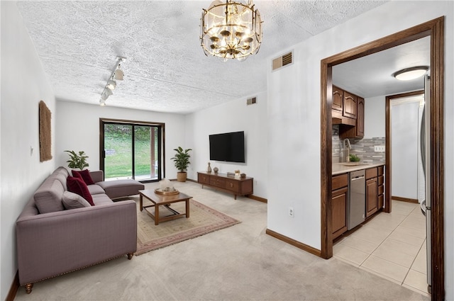 2011 Thornberry Dr, Ross Twp, PA 15237 - living room with a textured ceiling, a chandelier, light carpet, and track lighting