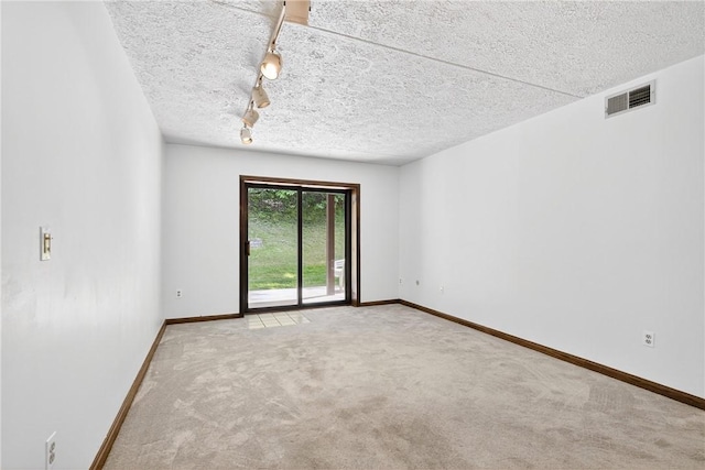 2011 Thornberry Dr, Ross Twp, PA 15237 - empty room featuring rail lighting, carpet, and a textured ceiling