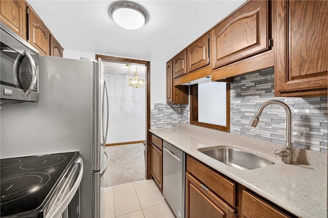 2011 Thornberry Dr, Ross Twp, PA 15237 - kitchen with appliances with stainless steel finishes, light countertops, backsplash, light tile patterned floors, and brown cabinetry