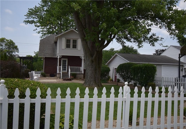 321 Hansen Ave, Franklin Twp, PA 16117 - view of front of home featuring covered porch, a fenced front yard, an attached garage, and concrete driveway