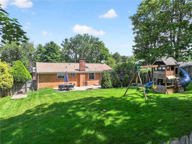555 Madison St, Mccandless, PA 15237 - back of house with a patio area, a playground, a fenced backyard, brick siding, and a chimney