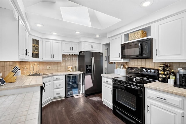 555 Madison St, Mccandless, PA 15237 - kitchen featuring black appliances, tile counters, beverage cooler, tasteful backsplash, and recessed lighting