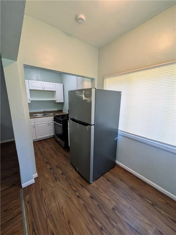 1310 Pirl St, Mckeesport, PA 15132 - kitchen featuring appliances with stainless steel finishes, white cabinets, dark wood-type flooring, and dark countertops