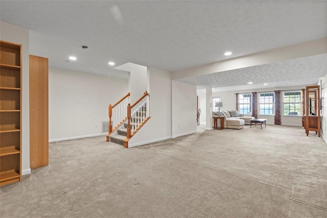 304 Horizon Dr, Monroeville, PA 15146 - unfurnished living room with carpet flooring, recessed lighting, stairs, and a textured ceiling