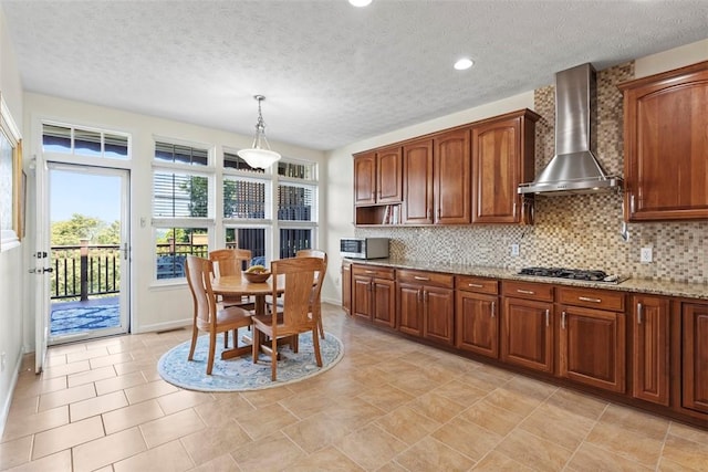 304 Horizon Dr, Monroeville, PA 15146 - kitchen with wall chimney range hood, stainless steel appliances, a textured ceiling, tasteful backsplash, and light stone countertops