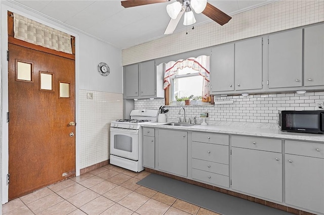 107 Imogene Rd, Greenfield, PA 15217 - kitchen with white gas range, black microwave, gray cabinets, ceiling fan, and crown molding
