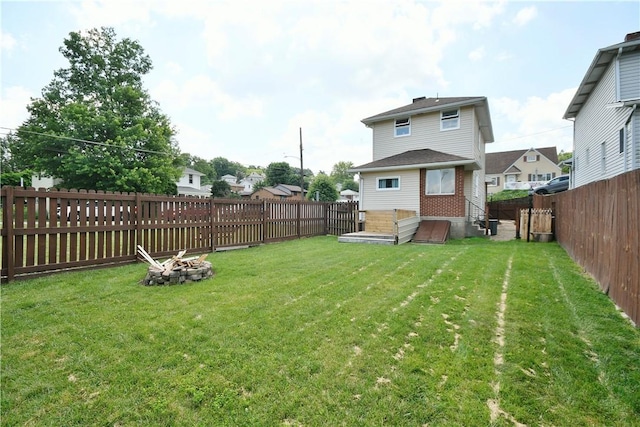 404 Emerson, Munhall, PA 15120 - back of property with an outdoor fire pit, a fenced backyard, a residential view, and brick siding
