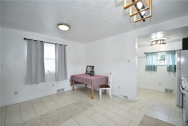 404 Emerson, Munhall, PA 15120 - tiled dining area featuring baseboards and a textured ceiling