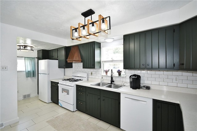404 Emerson, Munhall, PA 15120 - kitchen with white appliances, decorative backsplash, light countertops, decorative light fixtures, and a chandelier