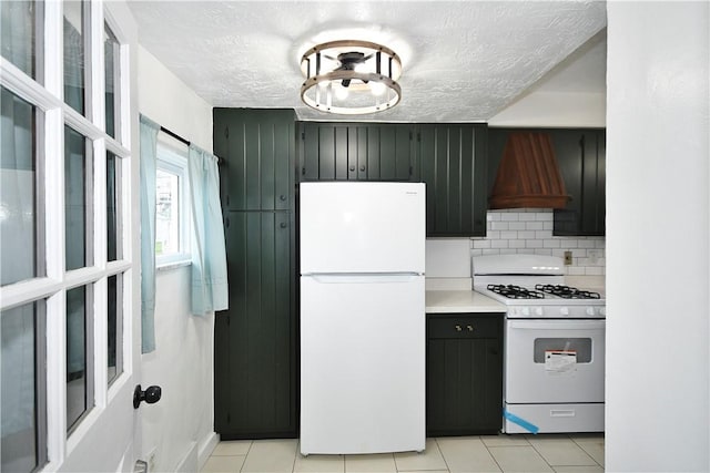 404 Emerson, Munhall, PA 15120 - kitchen with white appliances, premium range hood, light countertops, light tile patterned floors, and tasteful backsplash