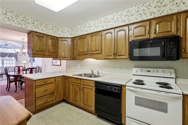 166 Steeplechase Cir, West Deer, PA 15044 - kitchen featuring black appliances, light countertops, a peninsula, brown cabinetry, and wallpapered walls