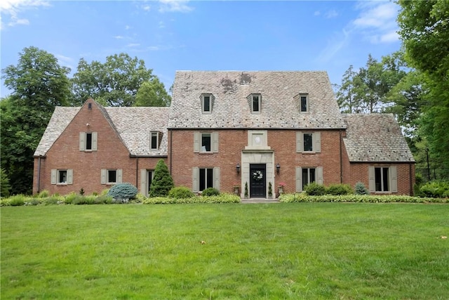 143 N Dr, Fox Chapel, PA 15238 - view of front of property with a high end roof, a front lawn, and brick siding