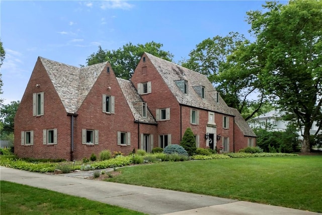 143 N Dr, Fox Chapel, PA 15238 - view of front of house featuring a high end roof, brick siding, and a front lawn