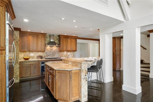 143 N Dr, Fox Chapel, PA 15238 - kitchen featuring wall chimney exhaust hood, granite tiled floors, a kitchen breakfast bar, recessed lighting, and stainless steel appliances