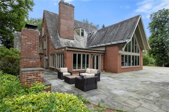 143 N Dr, Fox Chapel, PA 15238 - back of house with a high end roof, brick siding, a patio, a chimney, and an outdoor living space