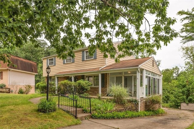 1449 Parkview Dr, Mccandless, PA 15101 - view of front of home featuring a sunroom, a front yard, and brick siding