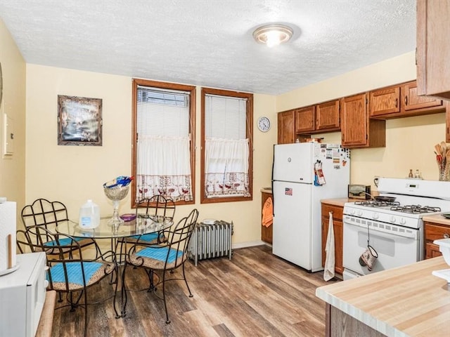 109 Ella St, Mckees Rocks, PA 15136 - kitchen with white appliances, a textured ceiling, wood finished floors, brown cabinets, and light countertops