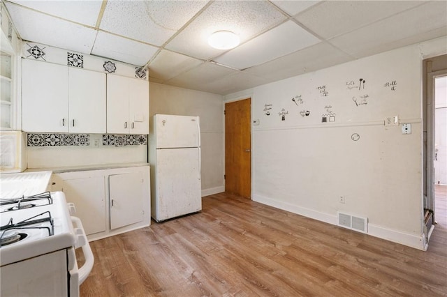 302 38th St, Lawrenceville, PA 15201 - kitchen featuring white appliances, a paneled ceiling, white cabinetry, light wood-style floors, and light countertops