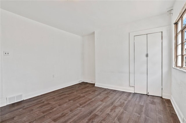 302 38th St, Lawrenceville, PA 15201 - unfurnished bedroom with dark wood-style flooring and a closet