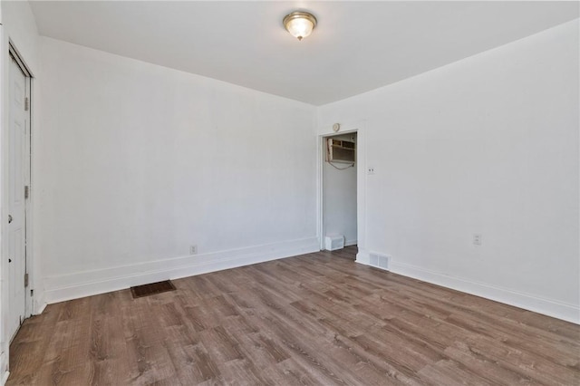302 38th St, Lawrenceville, PA 15201 - unfurnished room featuring wood finished floors and a wall mounted air conditioner