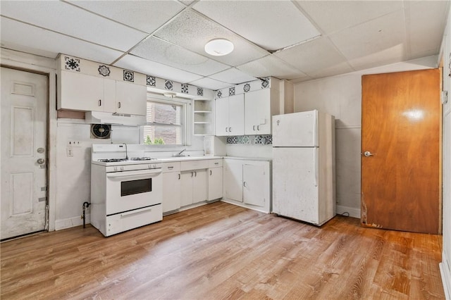 302 38th St, Lawrenceville, PA 15201 - kitchen with white appliances, under cabinet range hood, light countertops, white cabinets, and light wood finished floors