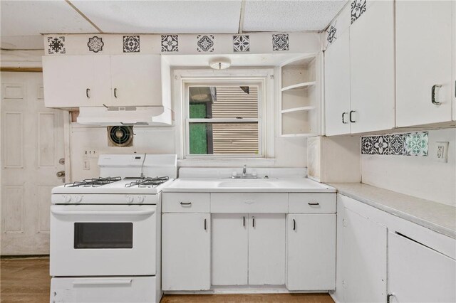 302 38th St, Lawrenceville, PA 15201 - kitchen with white gas stove, white cabinets, under cabinet range hood, light countertops, and open shelves
